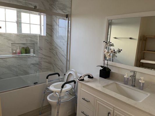 Bathroom with accessibility features including roll-in shower